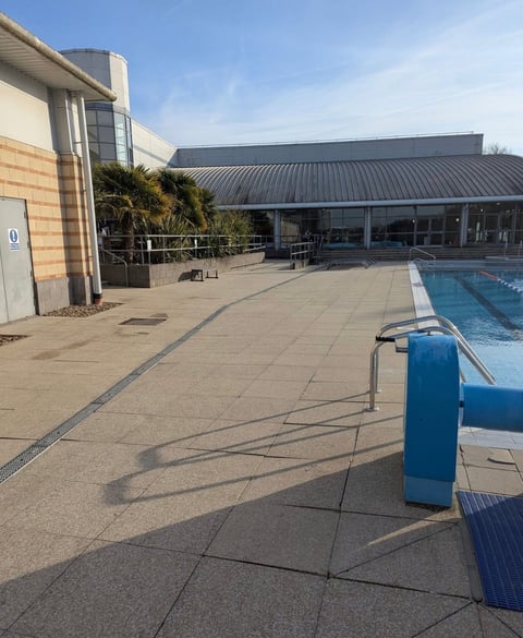 Outdoor swimming pool and pavilion at commercial facility