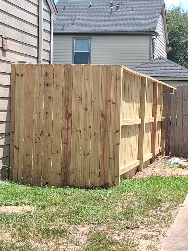 Wooden storage shed with open shelving located in a residential backyard next to a house