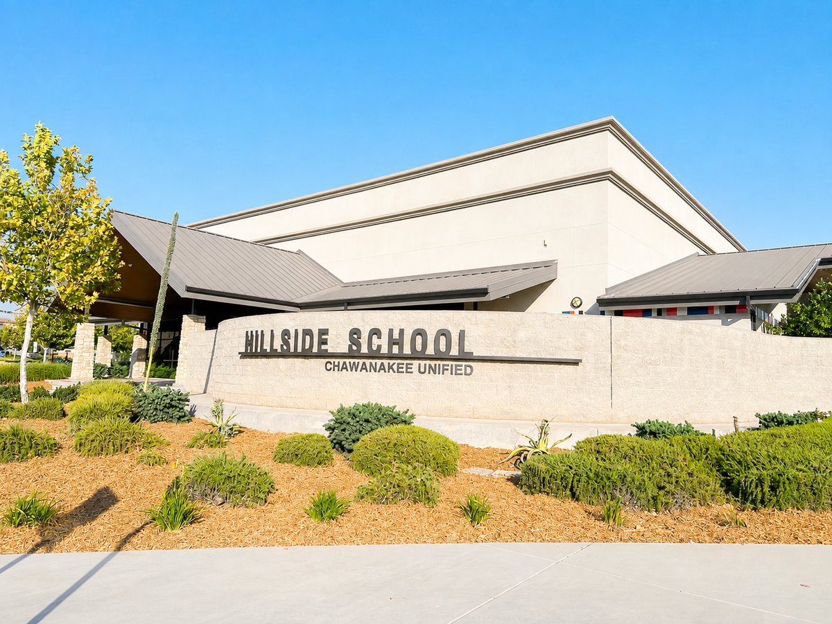 Hillside School building exterior with modern architecture, Chawanakee Unified signage, landscaping, and clear blue sky