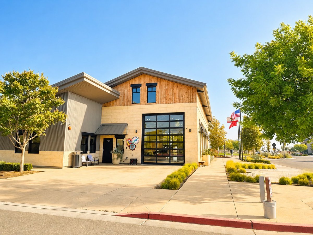 Modern commercial building with wood and concrete exterior and black garage door