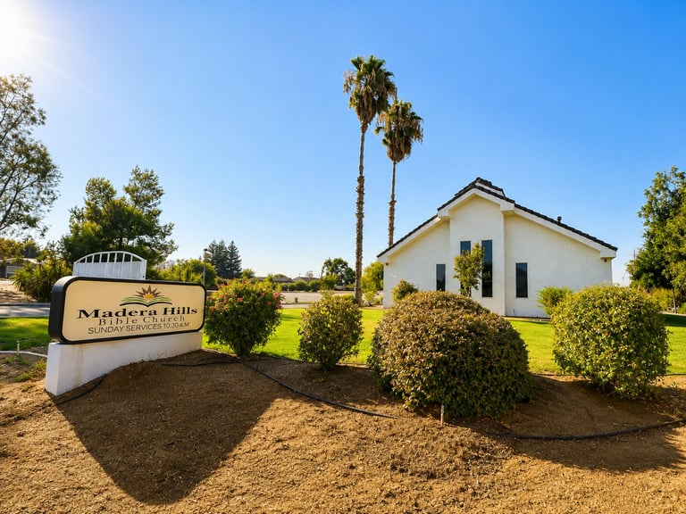 Madera Hills Bible Church exterior — white building with palm trees and manicured landscaping