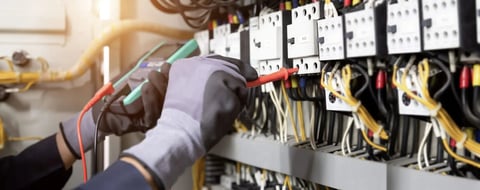 Electrician using multimeter on circuit breaker panel — CN Electrical panel upgrade service in Chilliwack, BC
