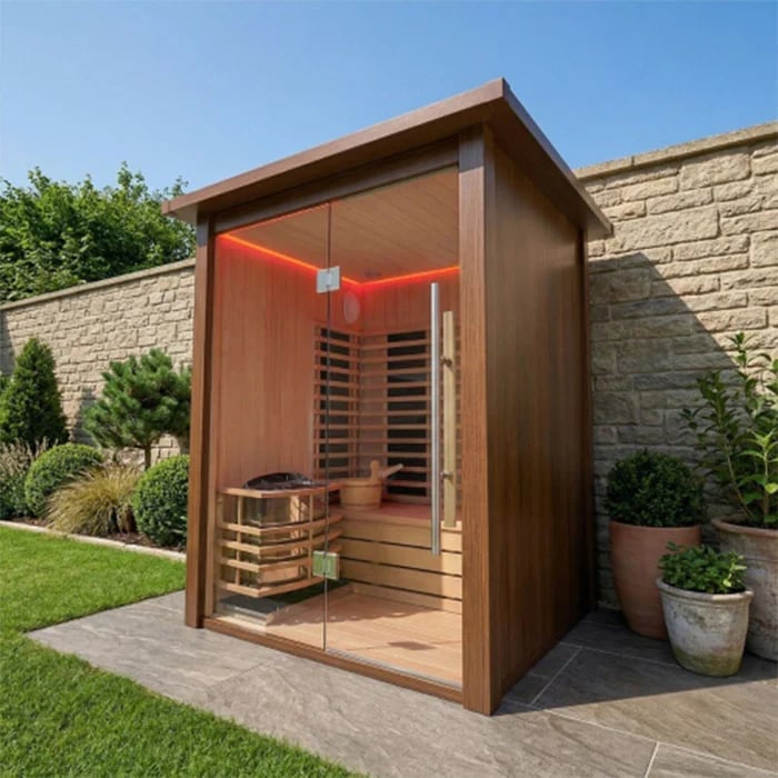 Modern outdoor infrared sauna cabin with wooden exterior and glass door in a backyard garden setting
