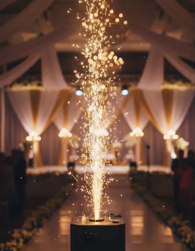 Gold fountain fireworks display in elegant event venue with draped fabric and ambient lighting