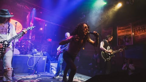 Full band with colorful stage lighting
