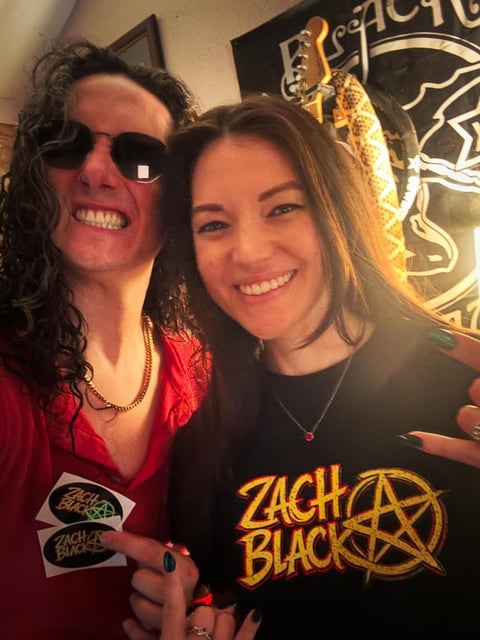 Band members smiling with stickers