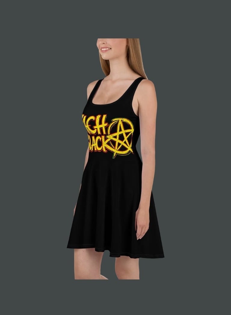 Woman wearing a black sleeveless dress with yellow Witch Doctor graphic design on the front, looking upward against a gray background