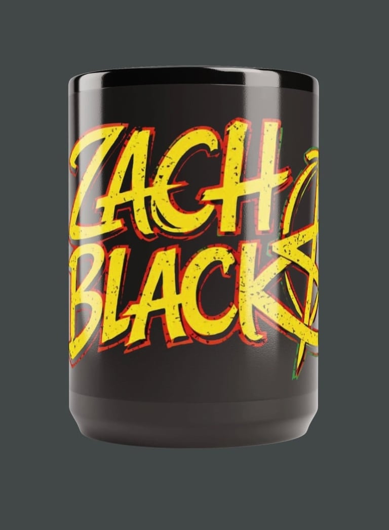 Black ceramic mug with yellow and red ACH BLACK text and graphic design on gray background