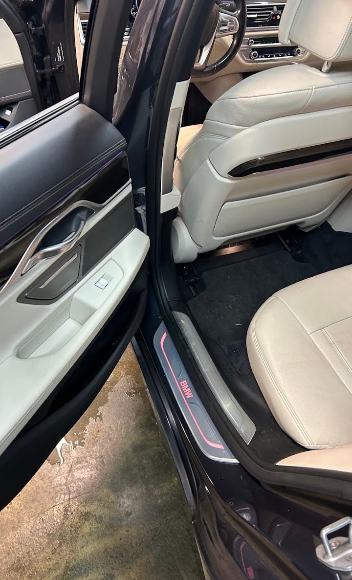 Luxury SUV with open doors showing cream leather interior
