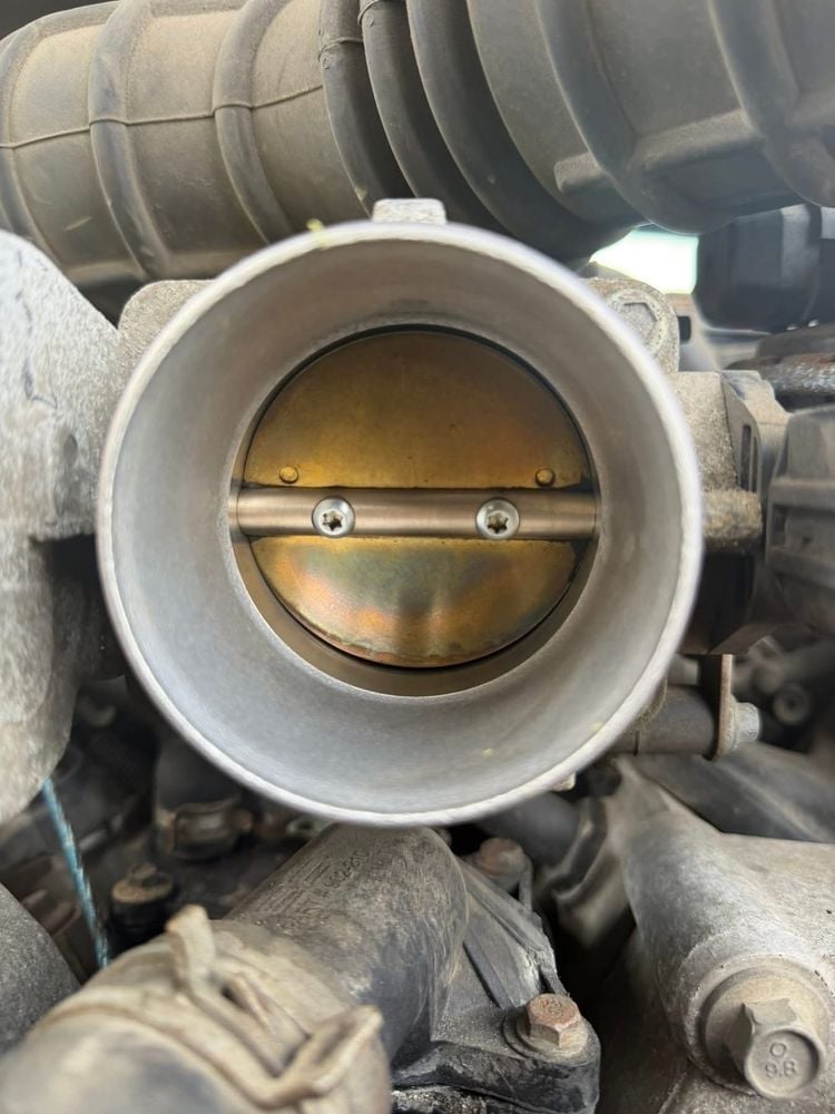 Throttle body after service — clean brass butterfly valve