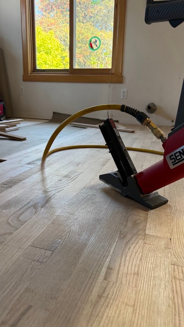 Wood floor installation with pneumatic flooring nailer tool