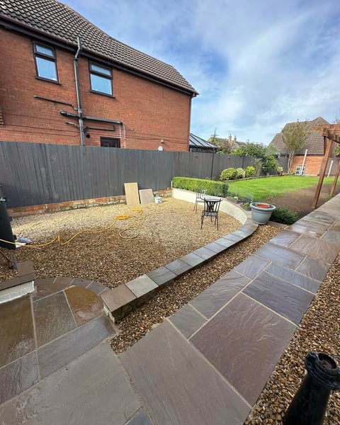 Garden makeover — paved patio with gravel areas, new fence and chair