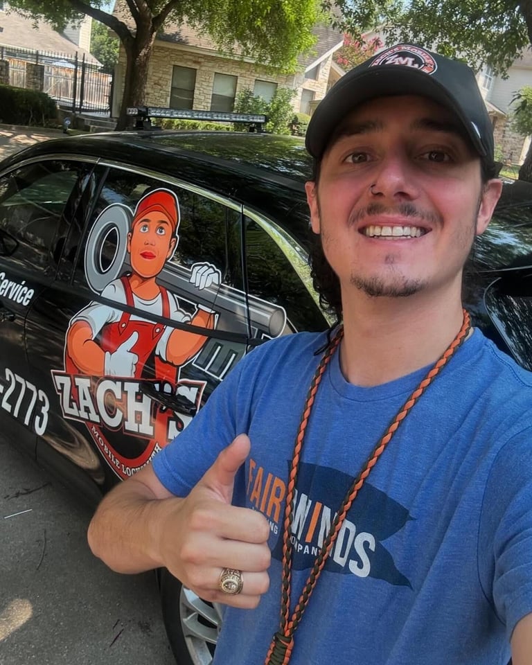 Man in blue shirt and cap giving thumbs up next to black van with cartoon character artwork