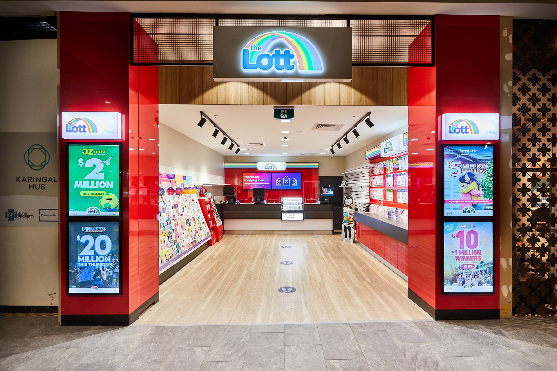 JHB Shopfitters retail fit-out project: The Lott lottery storefront at Karingal Hub Shopping Centre Victoria with red pillars and blue neon signage