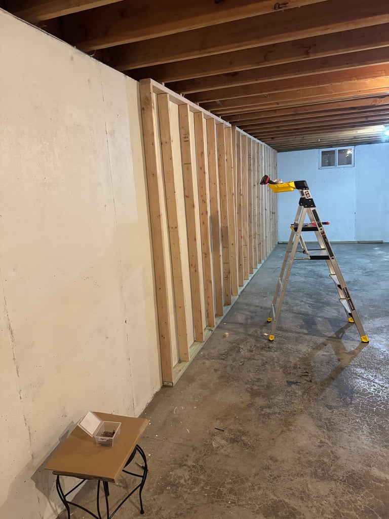 Construction work in progress wooden framing against drywall in basement