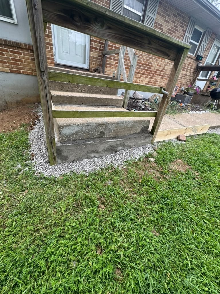 Wooden shelf unit with moss and algae growth standing on grass next to a brick building