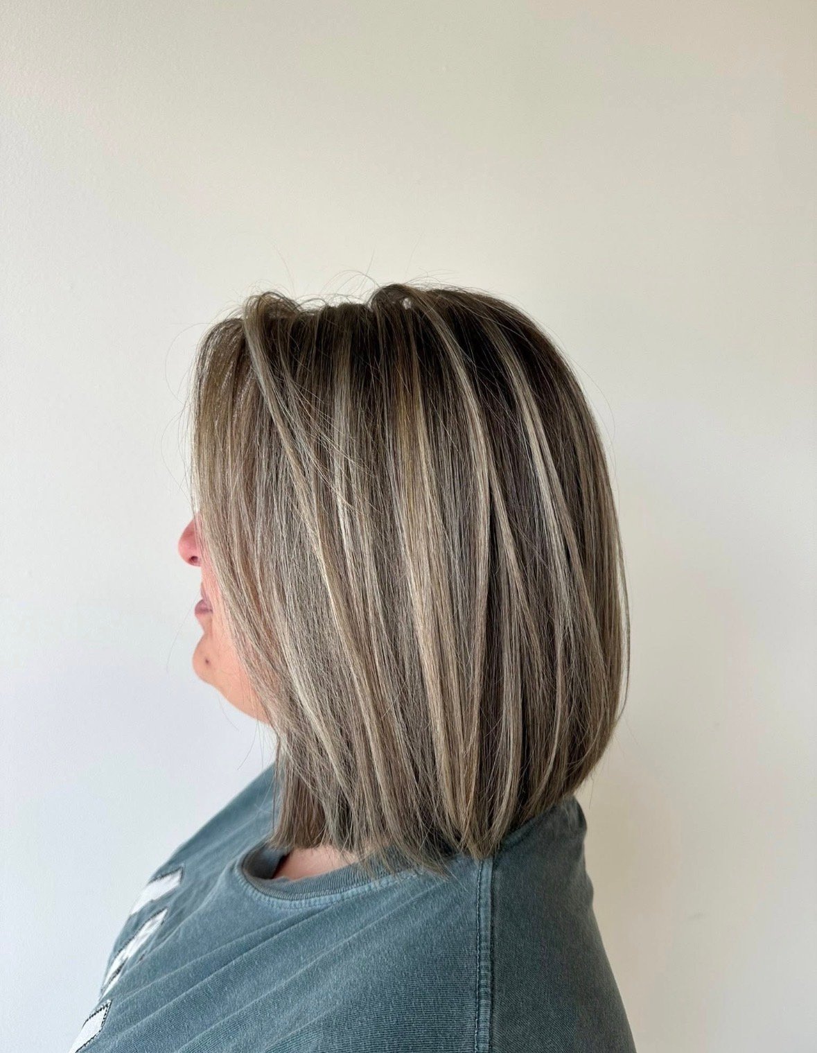 Back view of a finished shoulder-length cut with gray and dark brown lowlights, straight and center-parted.