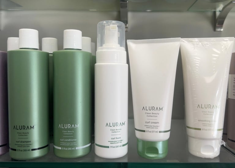 Aluram Curl Shampoo, Curl Conditioner, Curl Foam, Curl Cream and Smoothing Cream displayed at Trendsetters
