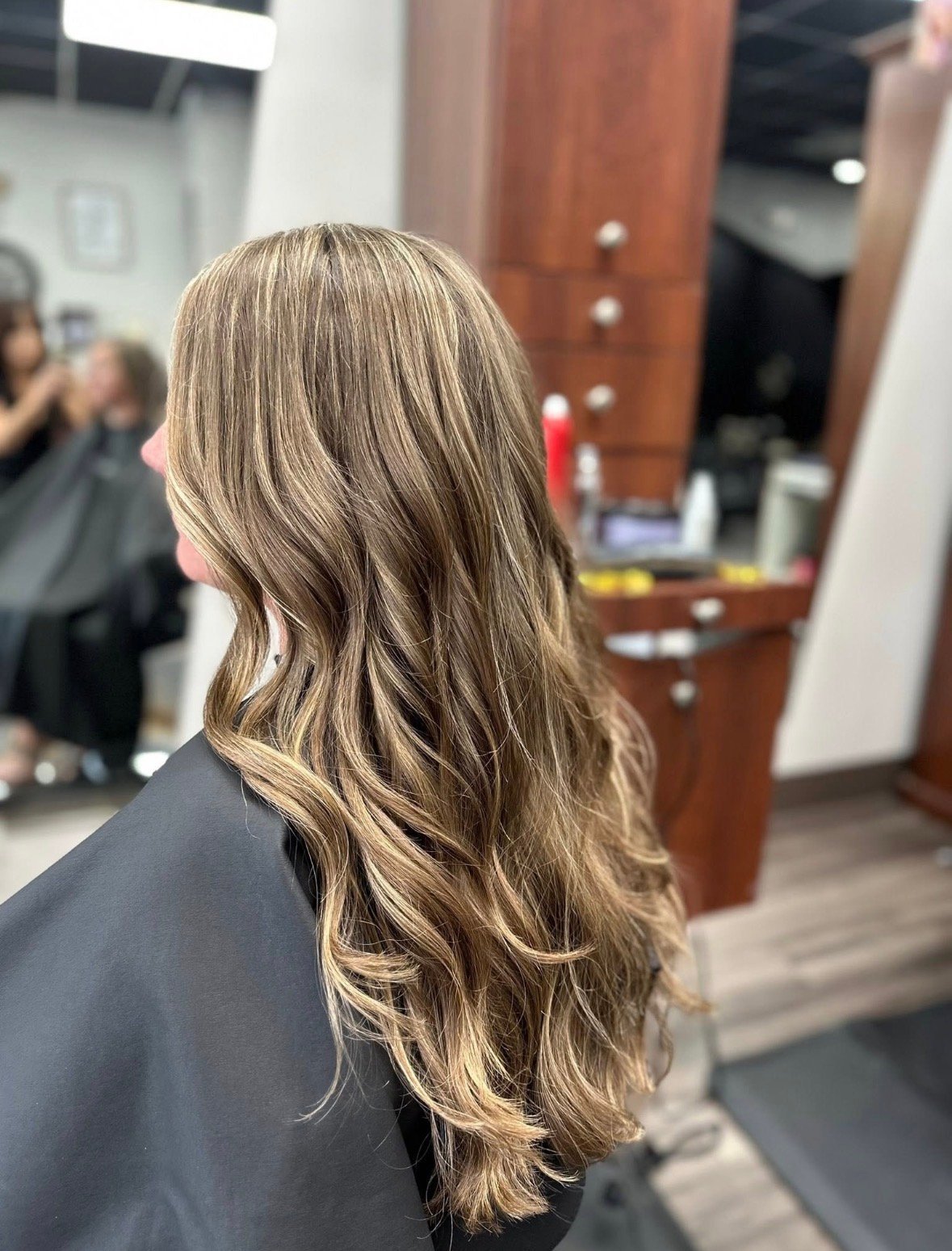 Back view of long, wavy, blonde and brown highlighted hair.