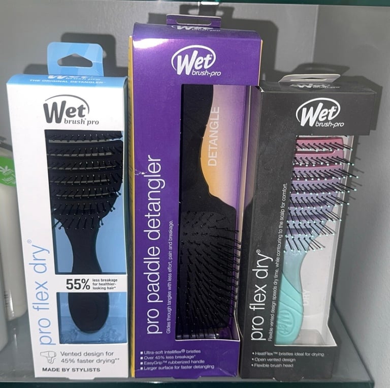 Wet Brush Pro Flex Dry brushes and a Pro Paddle Detangler displayed in their retail packaging.
