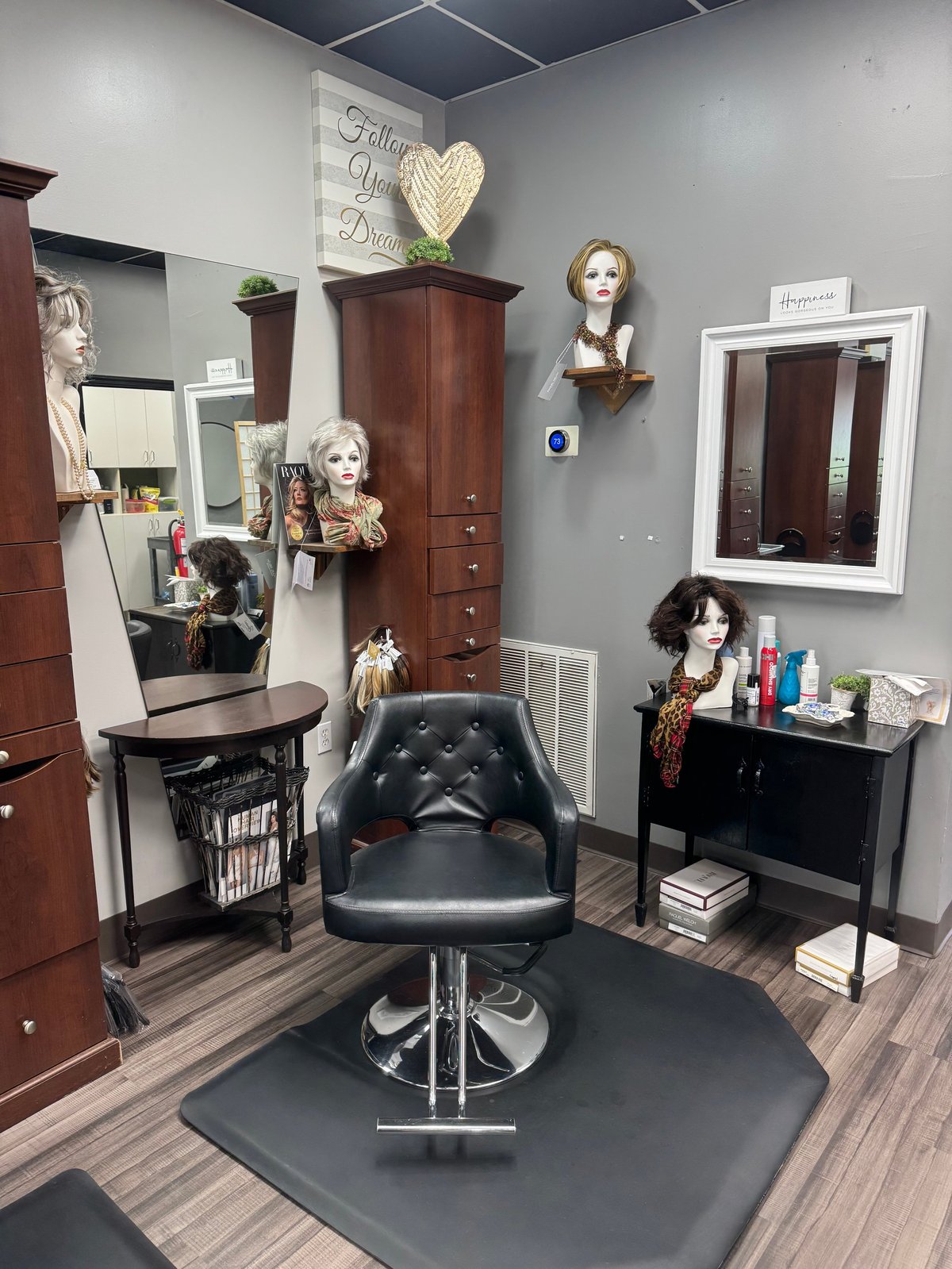 Private wig consultation room with mannequin heads and product displays