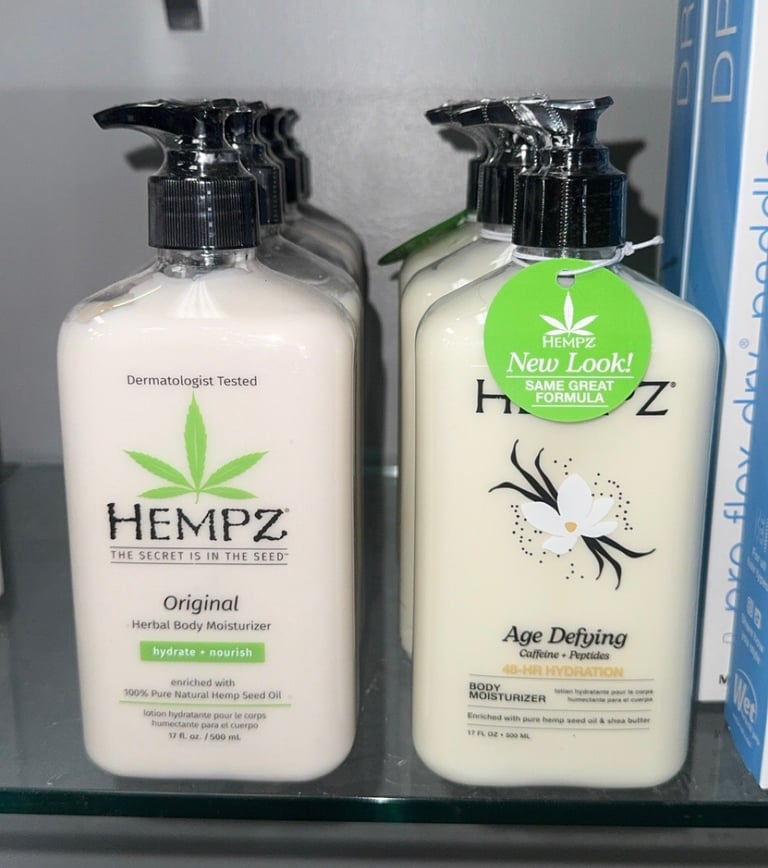 Hempz Original and Age Defying Herbal Body Moisturizer bottles displayed on a salon shelf.