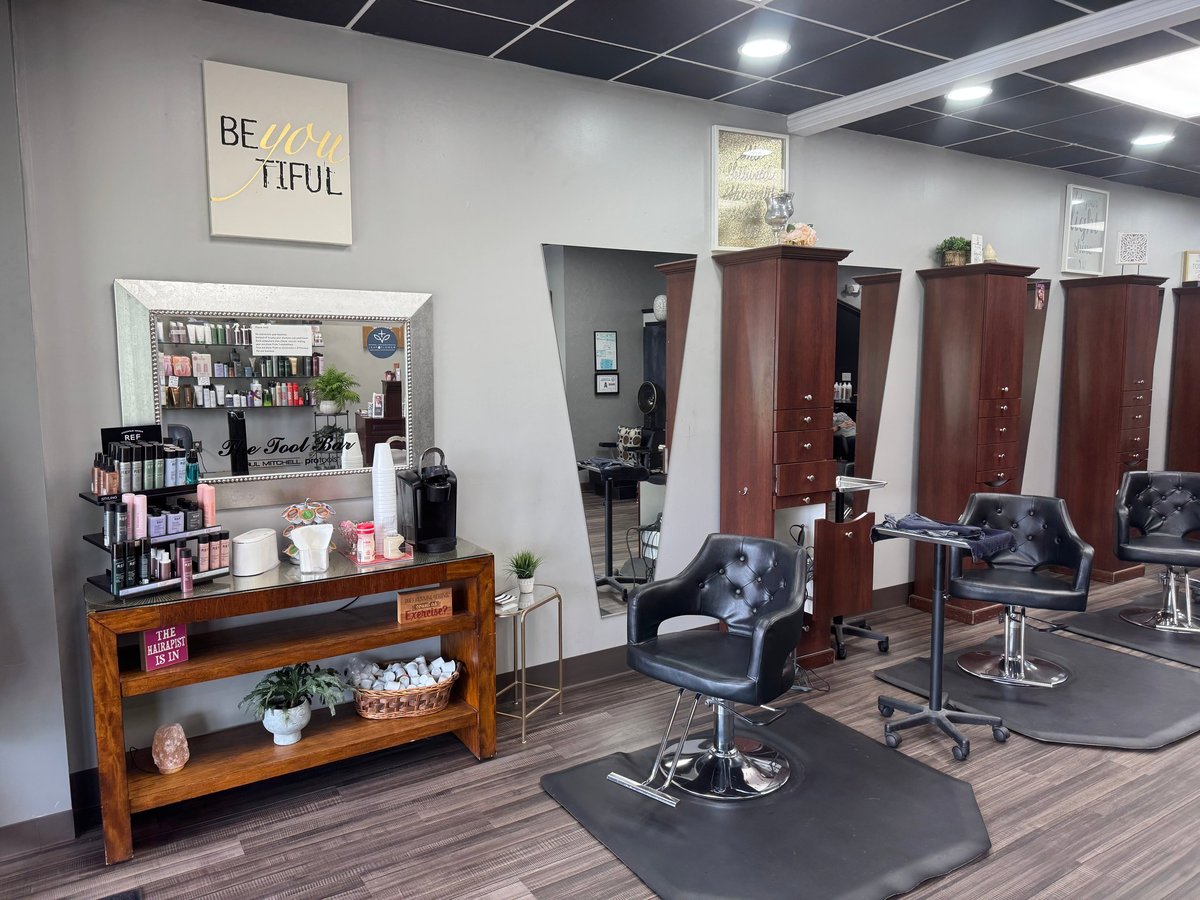 Modern hair salon interior with styling chairs and product displays