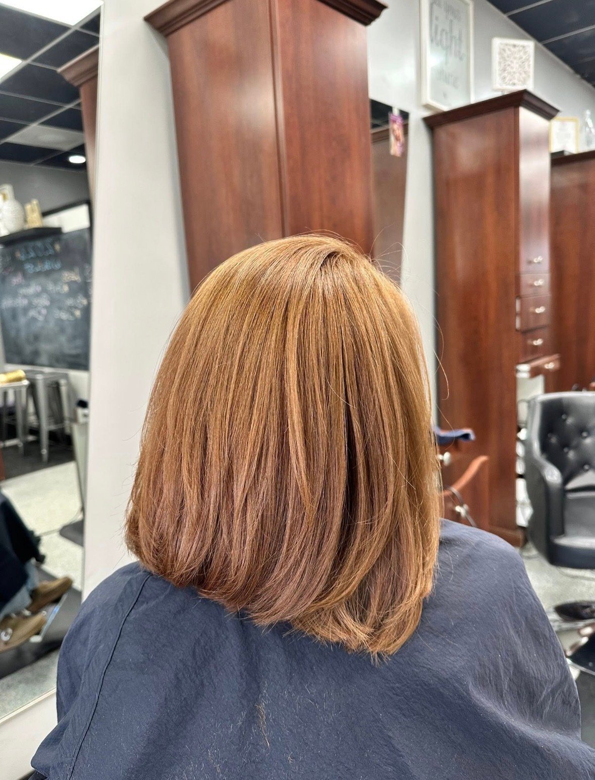 Back view of a shoulder-length copper-brown bob with soft layers.