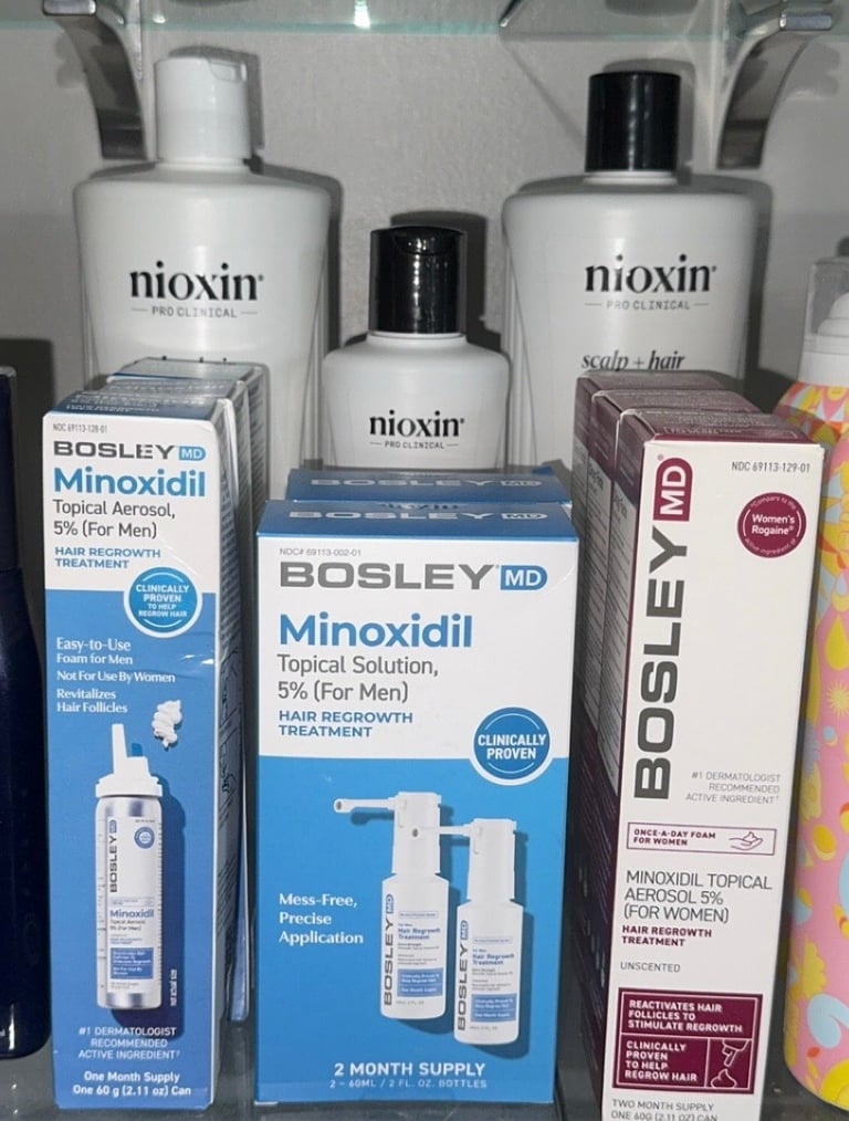 BosleyMD men’s and women’s 5% topical minoxidil products with Nioxin Pro Clinical bottles displayed in the background.