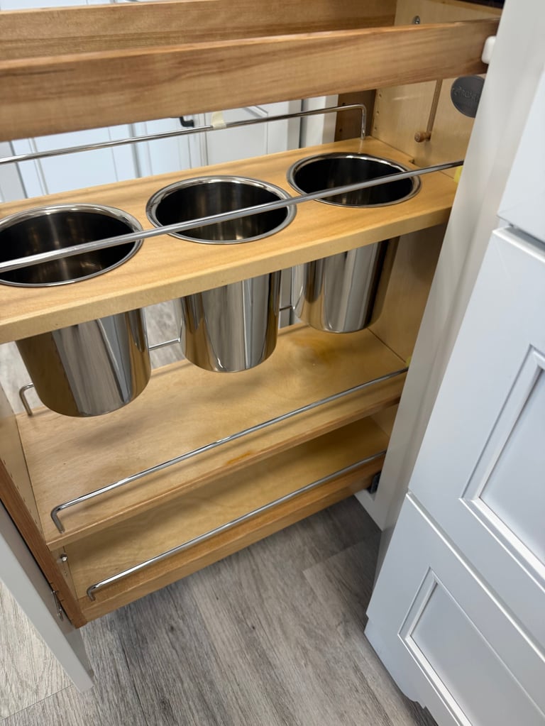 Wooden pull-out cabinet organizer with three stainless steel containers and slide-out drawers