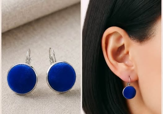 Pair of blue circular drop earrings shown front view and worn on a model with dark hair