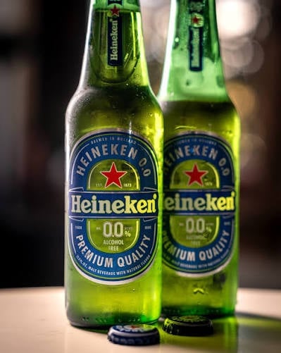 Two green Heineken 0.0 alcohol-free beer bottles with condensation, displaying the iconic red star logo and labels