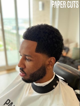 Paper Cuts member with a modern fade haircut and groomed beard