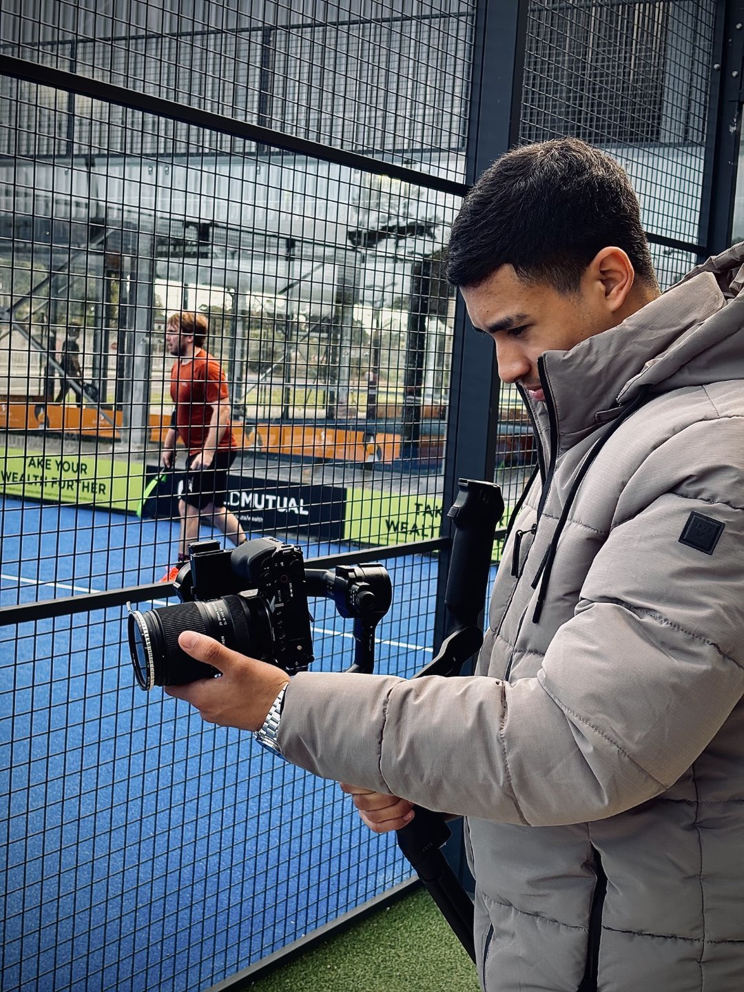 Dyaab filming a padel match with professional camera equipment
