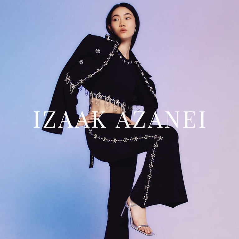 Woman in black designer outfit with chain embellishments against blue-to-pink gradient background, Izaak Azanei branding