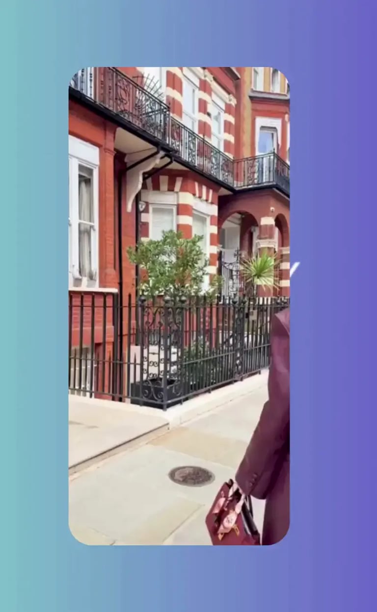 Video reel of London street scene with red brick townhouses and wrought-iron railings