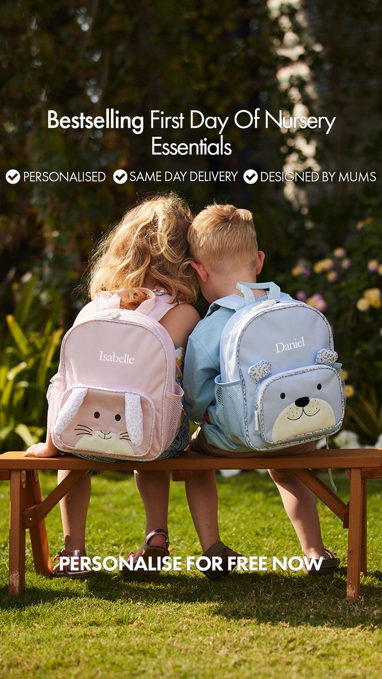Two young children sitting on a bench wearing personalized backpacks with animal designs in a garden setting