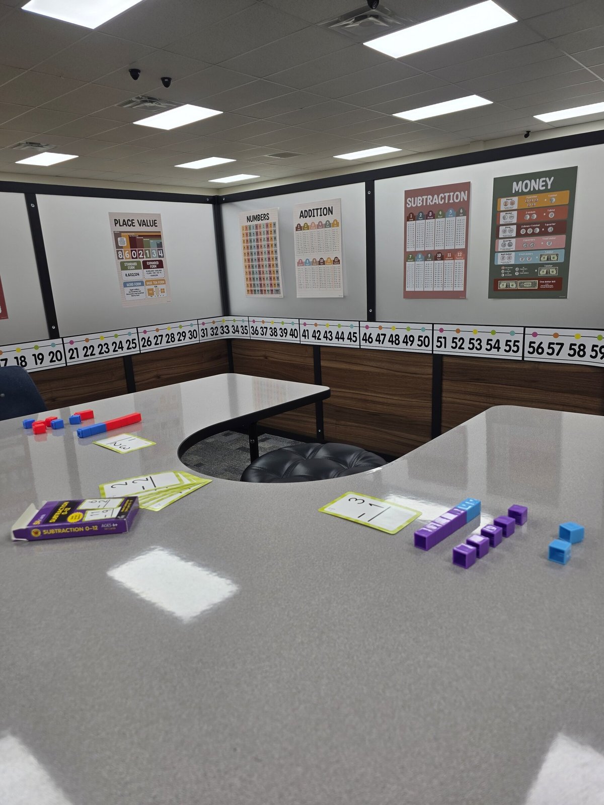 Small-group math table with counting cubes and flashcards at Avalon Academic Center