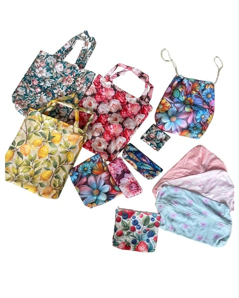 Collection of colorful floral patterned reusable shopping bags and pouches in various sizes and designs