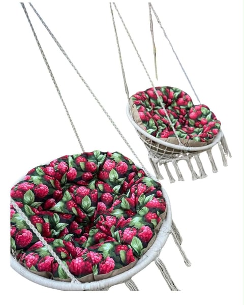 Two hanging baskets filled with vibrant pink roses and green foliage suspended by metal chains