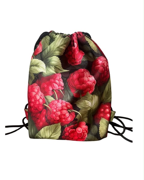 Drawstring backpack with red raspberry and green leaf botanical print on dark background