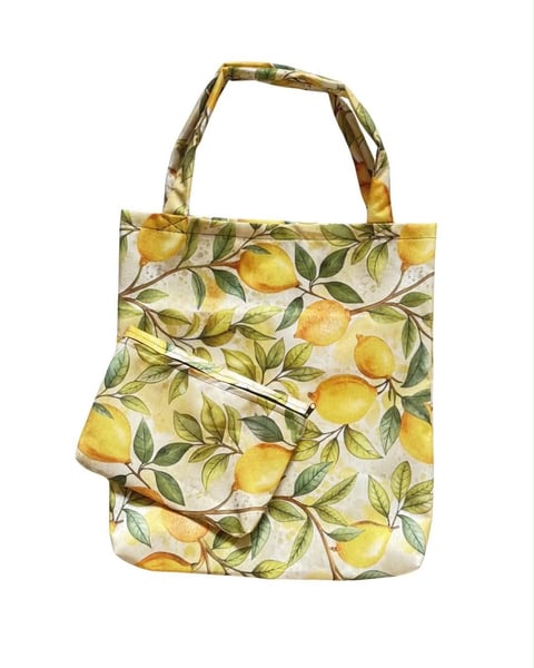 Canvas tote bag with yellow lemon and green leaf print on cream background