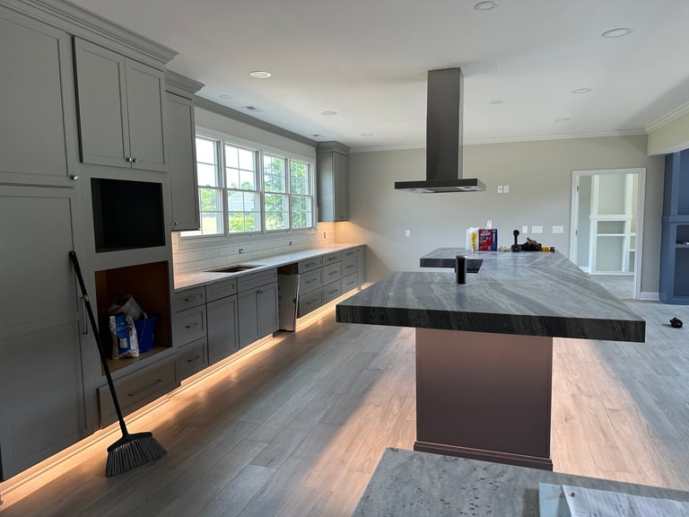 Modern gray kitchen remodel with recessed lighting, under-cabinet LED strips, island range hood, and clean electrical craftsmanship — Dylco Electric serving Central Indiana since 2004
