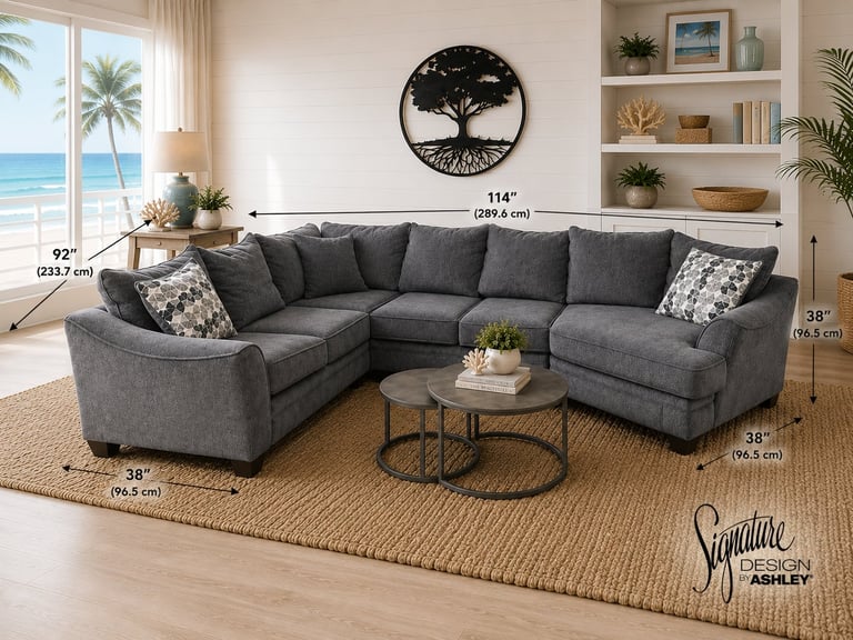 Gray upholstered sectional sofa in modern living room with ocean view, tree wall art, and jute rug