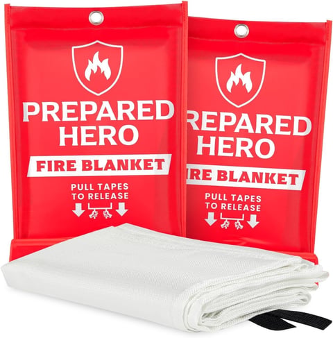 Two red fire blanket packages with a white folded blanket and black carrying pouch displayed below