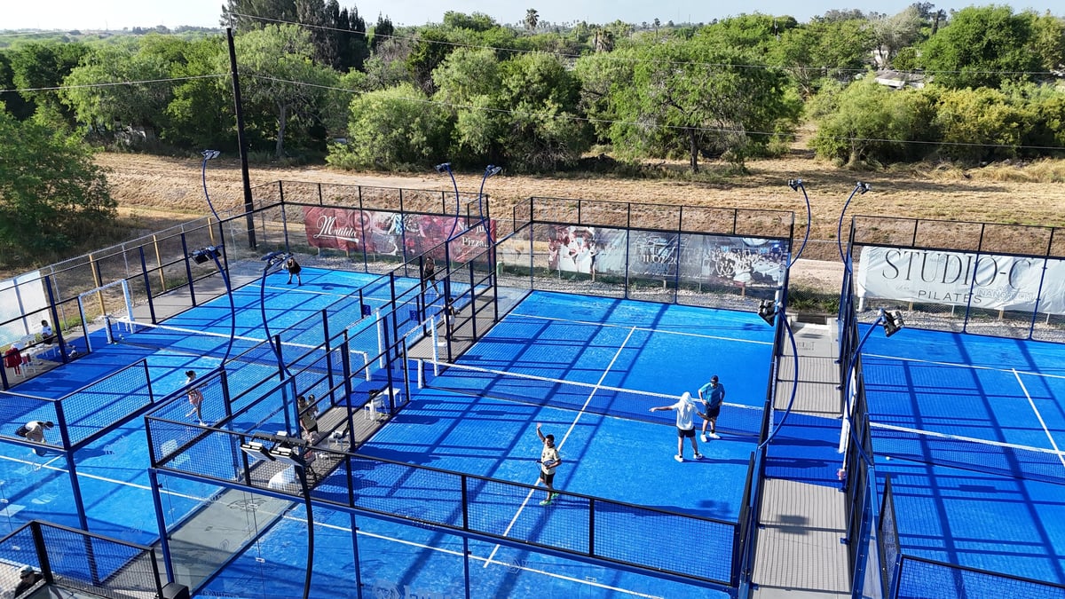 Aerial view of TT4 Padel Center blue padel courts with players