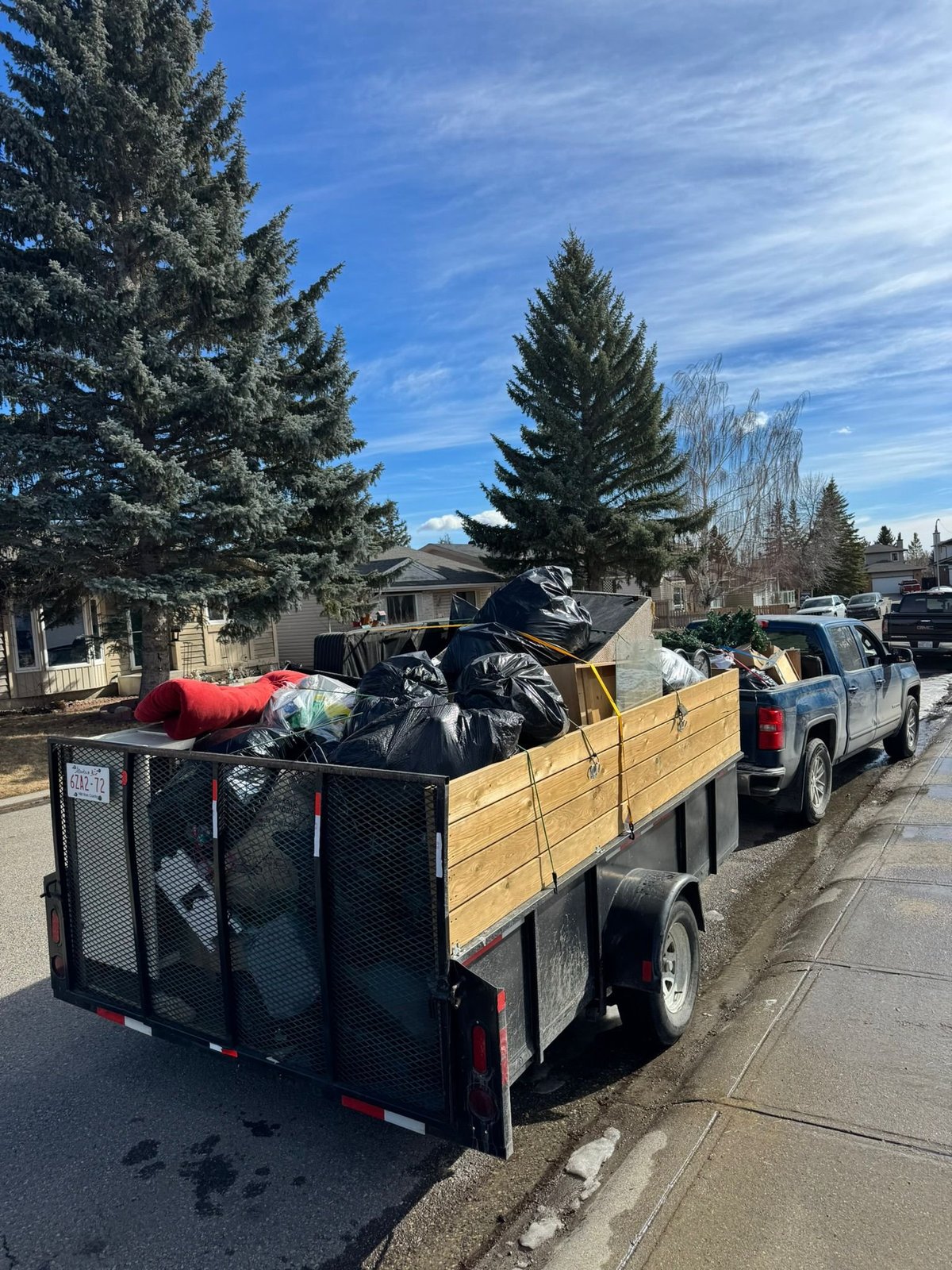 Monkey Junk Removal trailer loaded with junk bags in Calgary
