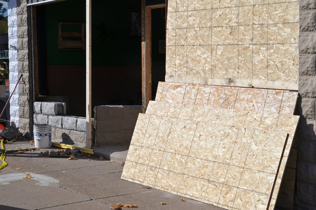 Stacked stone tile panels leaning against the exterior wall of the brewery under construction