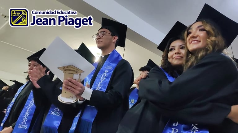 Graduates in black caps and gowns with blue sashes at Jean Piaget Educational Community graduation ceremony