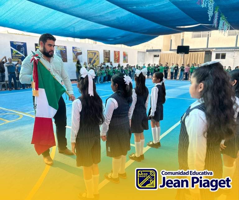 Man holding Italian flag during school assembly in gymnasium with students gathered on colorful blue and yellow court